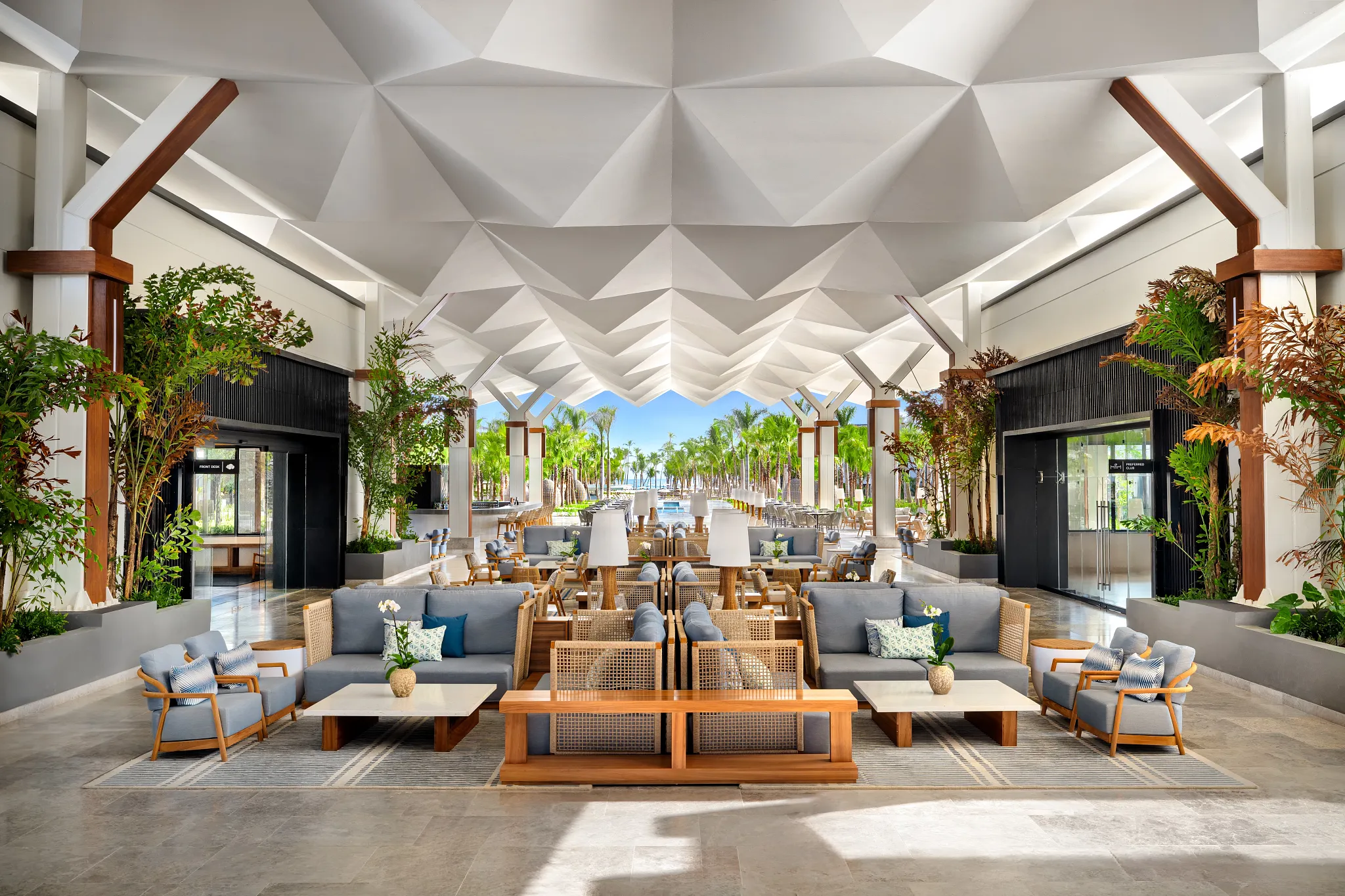 Open-air lobby at Secrets Tides Punta Cana with modern seating, tropical greenery, and ocean views.