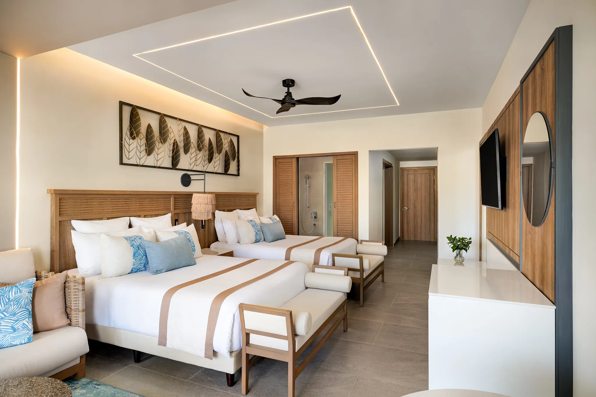 Preferred Club Junior Suite Ocean Front Swim Out with two double beds and modern décor at Secrets Tides Punta Cana.