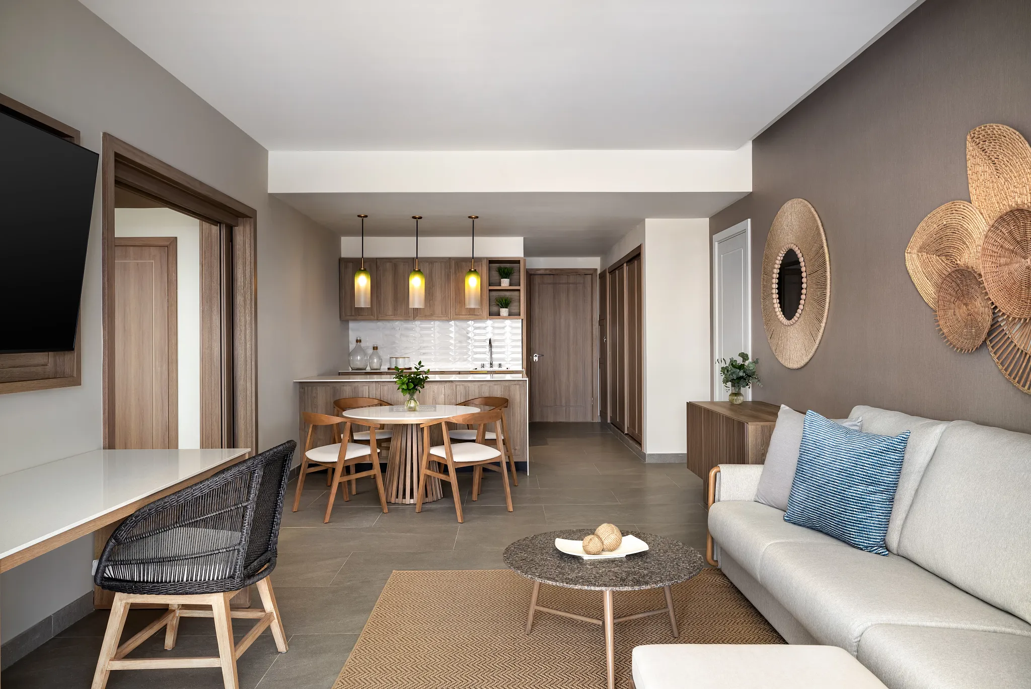 Preferred Club Master Suite Ocean Front Swim Out living room with dining area and ocean views at Secrets Tides Punta Cana.