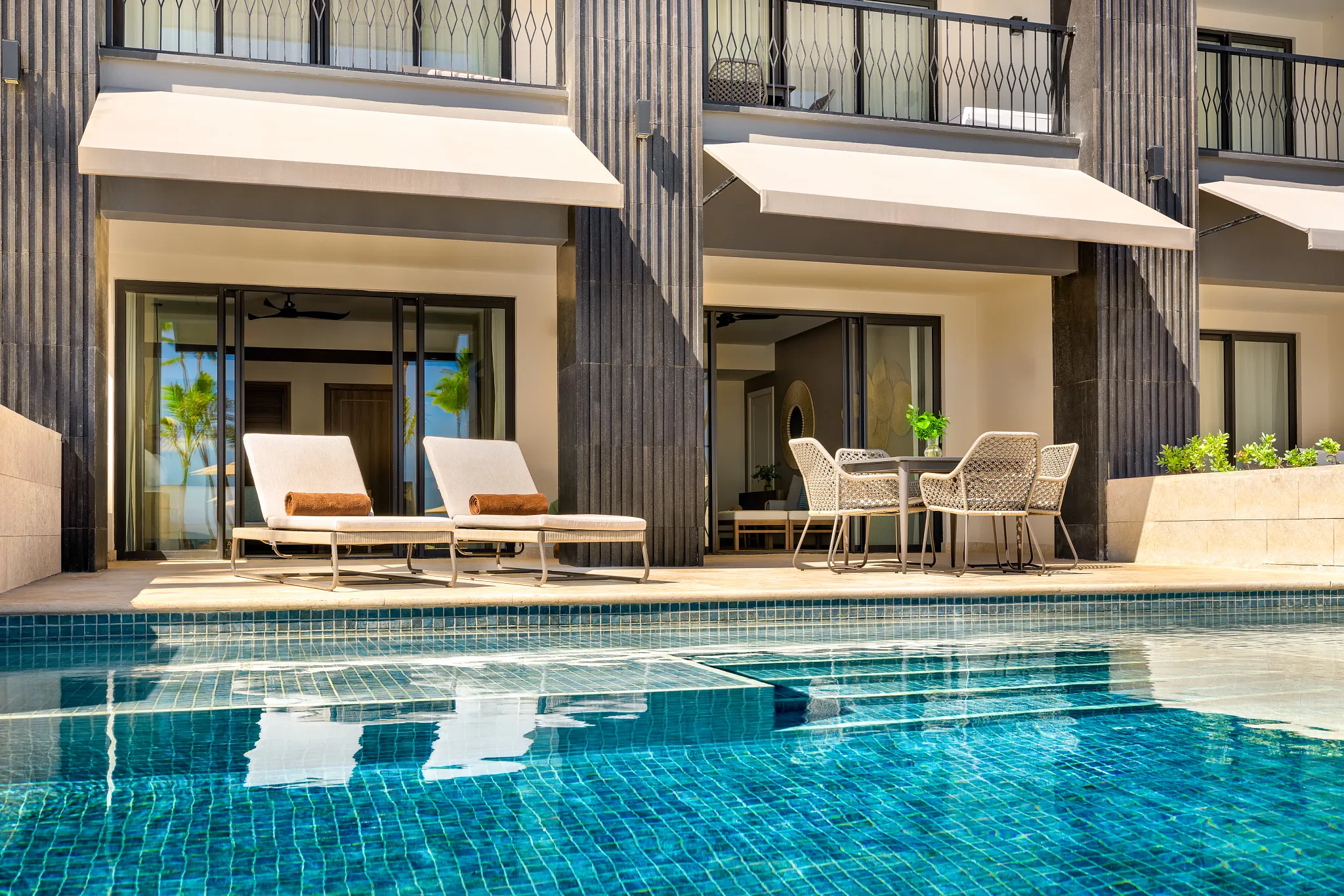 Preferred Club Master Suite Ocean Front Swim Out terrace with lounge chairs and direct pool access at Secrets Tides Punta Cana.