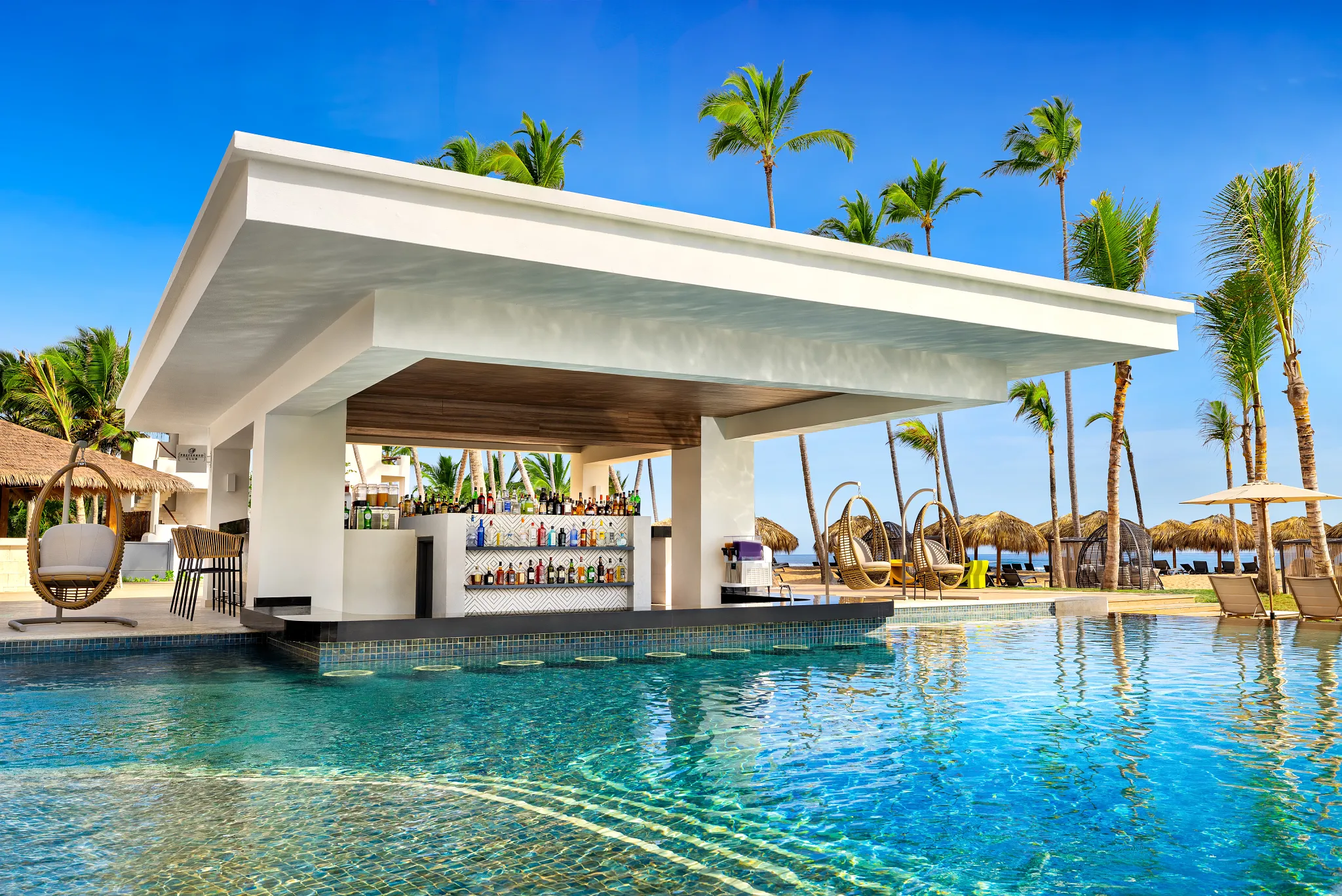 Preferred Club Pool Bar at Secrets Tides Punta Cana featuring a swim-up bar in an exclusive infinity pool with tropical cocktails.