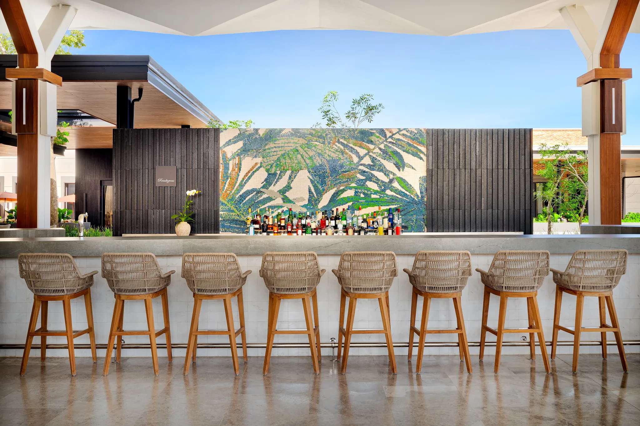Rendezvous lobby bar at Secrets Tides Punta Cana featuring a stylish open-air lounge with cocktails and relaxed seating.