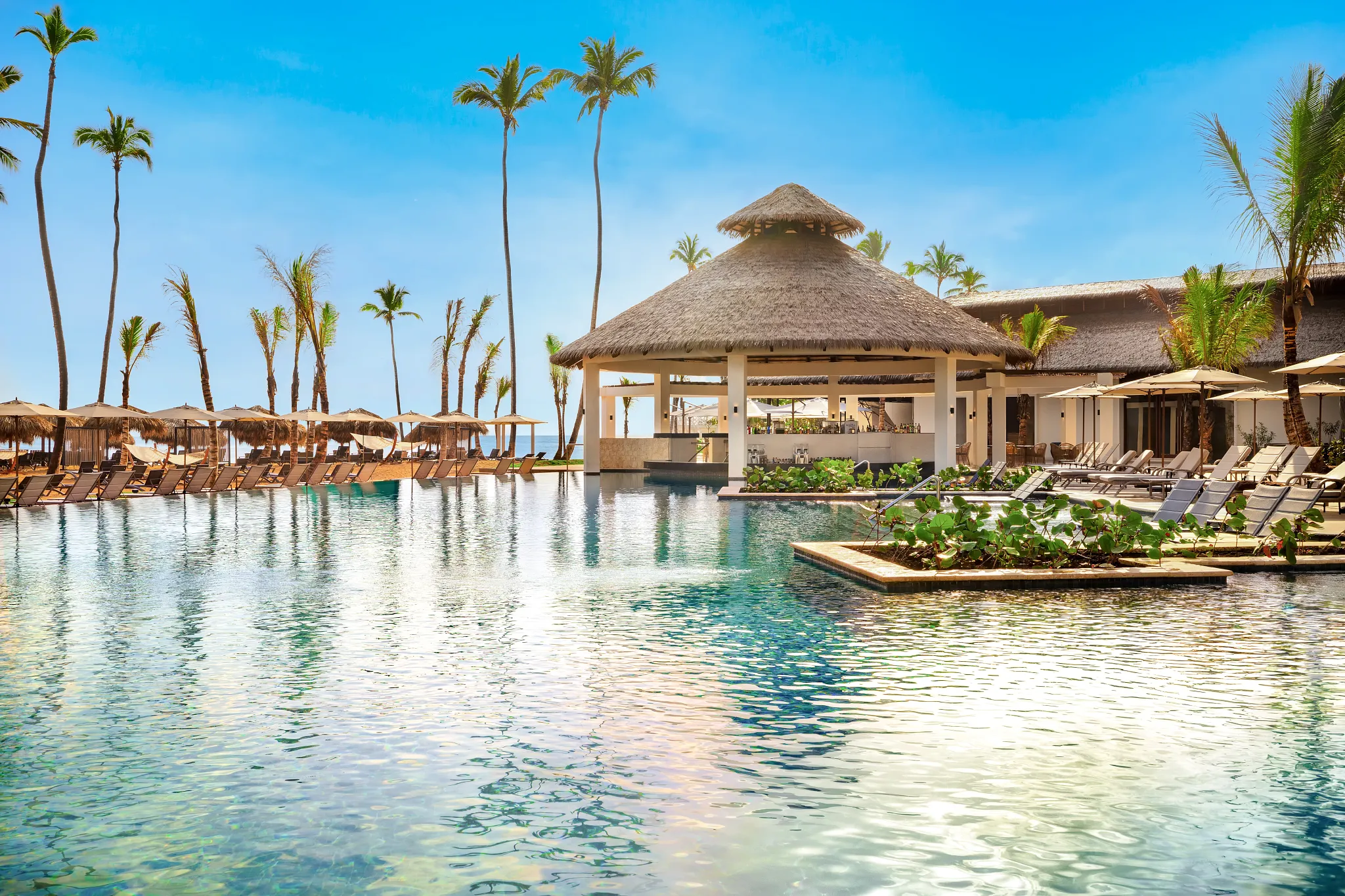 Sugar Reef pool bar at Secrets Tides Punta Cana featuring a lively poolside setting with tropical cocktails and sunny resort ambiance.
